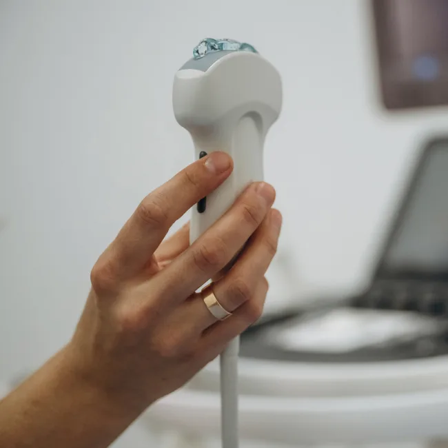 Ultrasound probe held in an imaging room